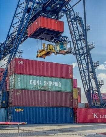 a crane is lifting a container onto a truck
